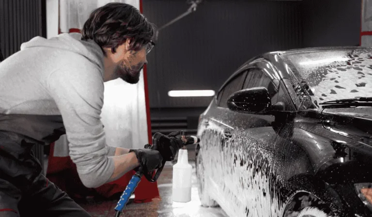 Car being washed carefully after window tint with water and sponge