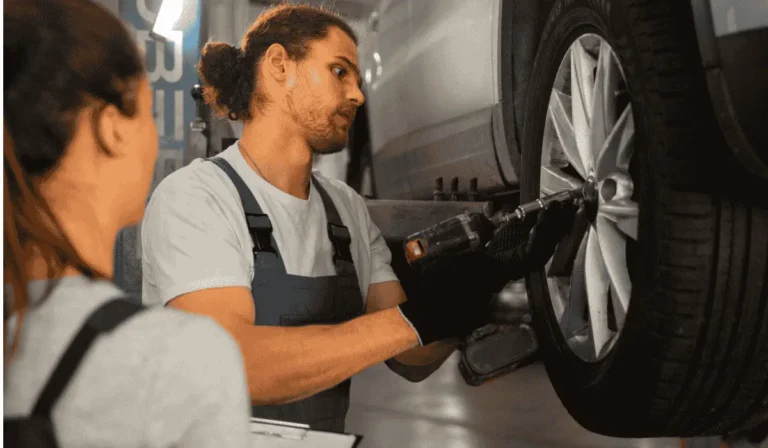 Mechanic changing a flat tire on a car in under 30 minutes
