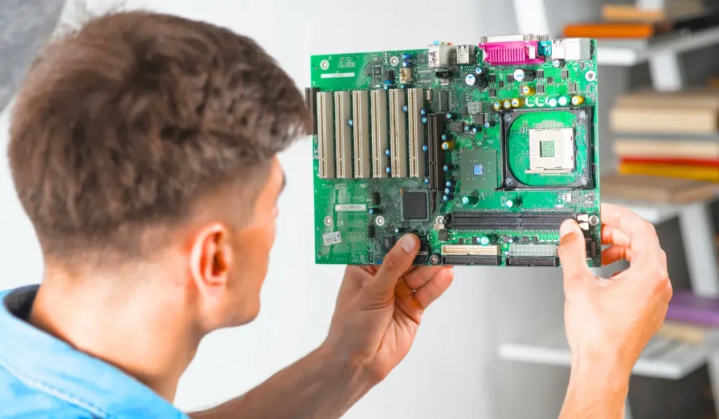 Close-up view of a motherboard being checked for damage caused by a GPU.