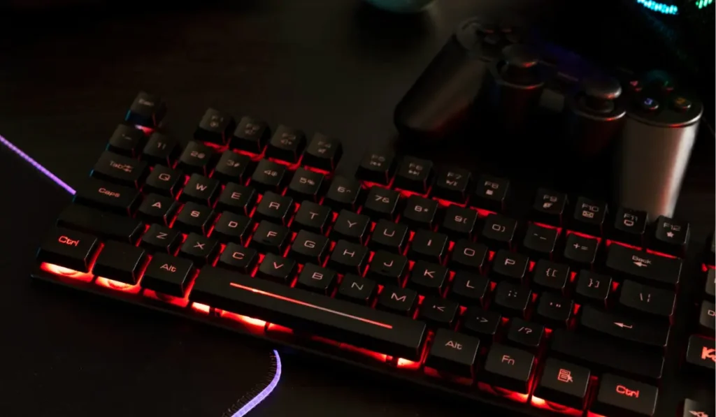 Gaming keyboard on a desk showing RGB lights, used for a buyer’s guide to the best gaming keyboards.