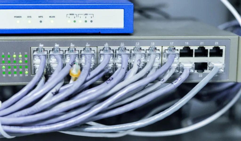 Ethernet cable connected to a router and computer showing how wired internet data is transmitted.